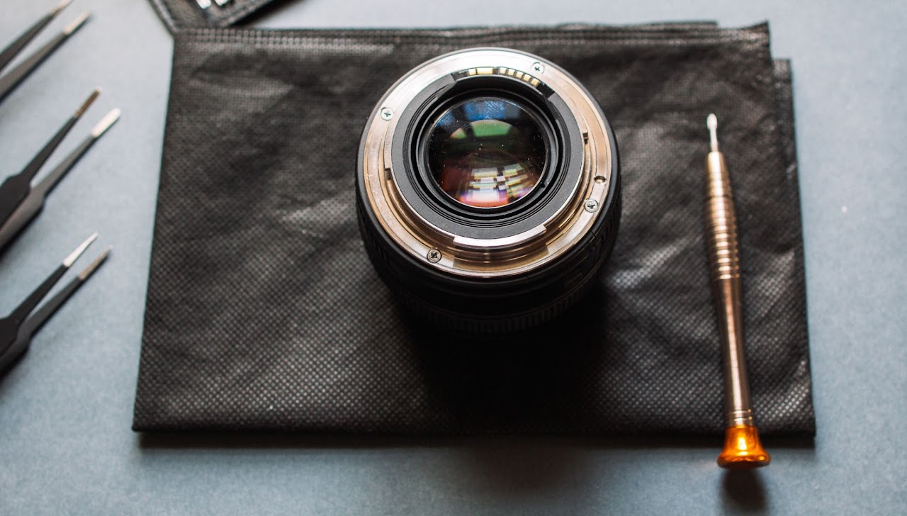 Lens and repair tools on a work surface