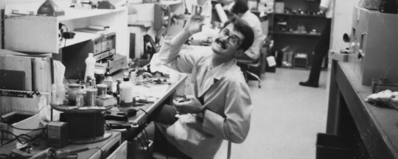 Mike working at a camera repair bench in the 1960s